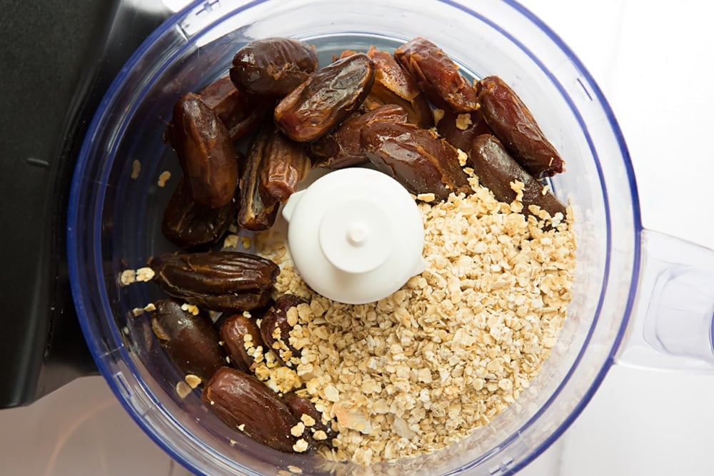 To make the date granola energy balls, add the dates and granola in a food processor
