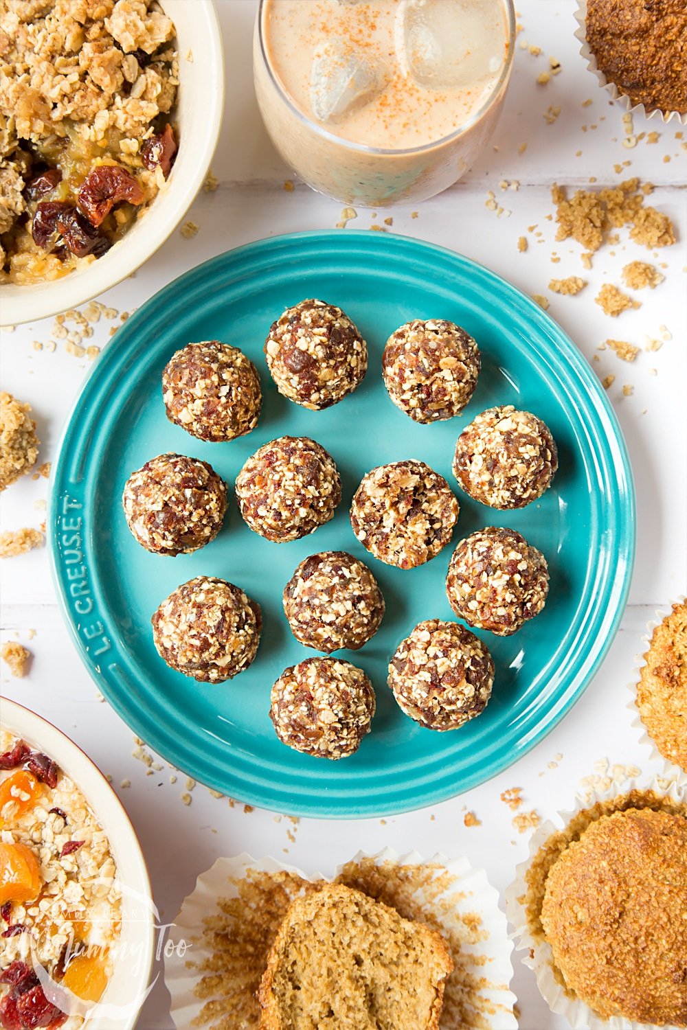 Overhead shot of date granola energy balls served on a blue Le Creuset plate