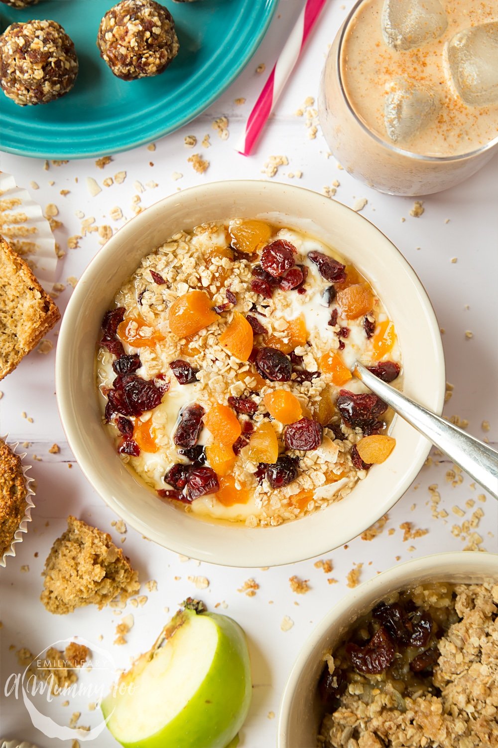 Overhead shot of a bowl filled with yogurt granola with honey and dried fruit