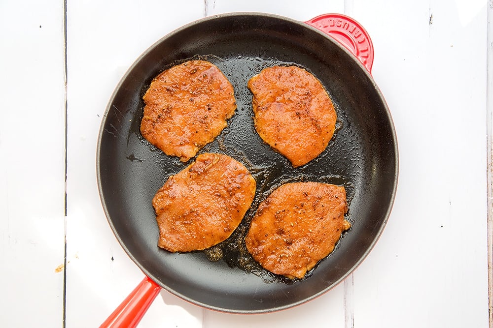 The marinated pork medallions are cooked in frying pan
