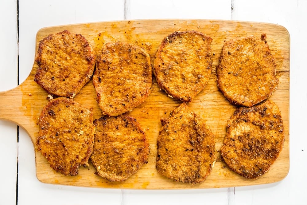 Marinated pork medallions resting on a chopping board