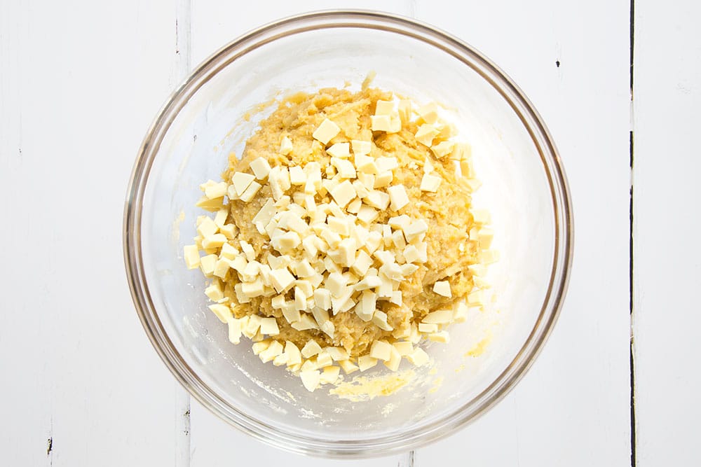 White chocolate is stirred into the cookie dough