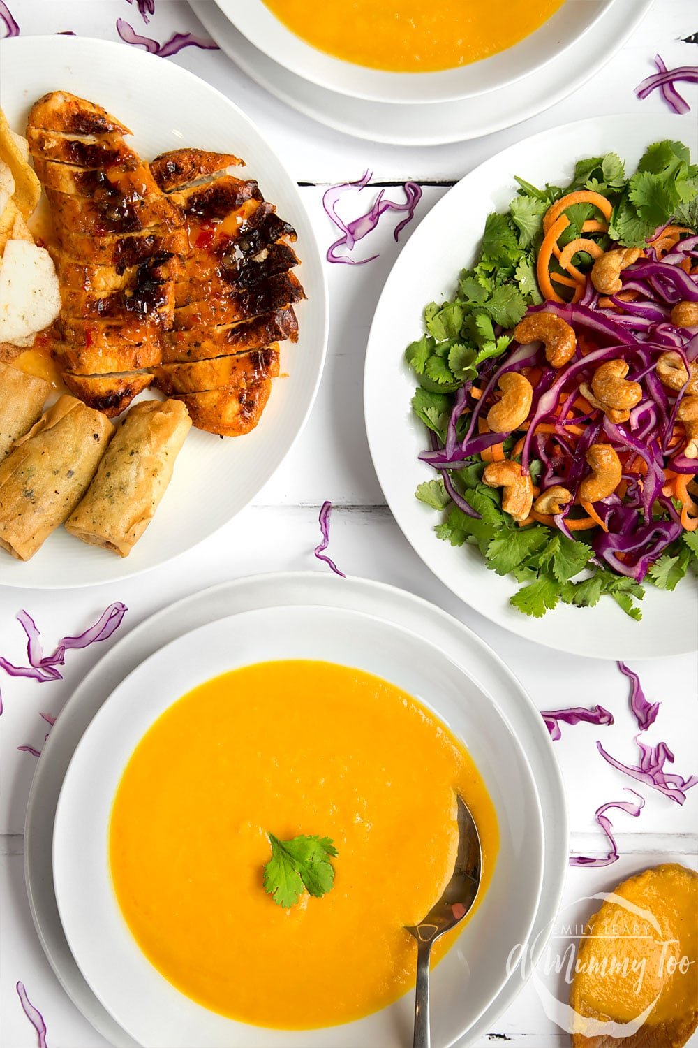 Thai curry and coconut soup, shown on a table with other Thai inspired dishes