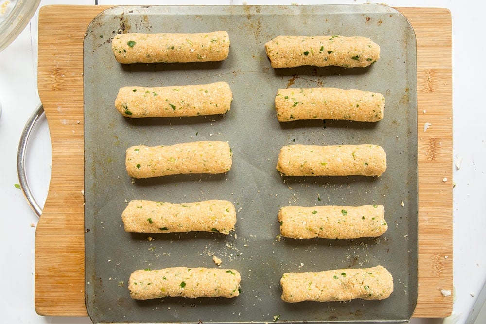The veggie sausages lined on a baking tray ready to be baked