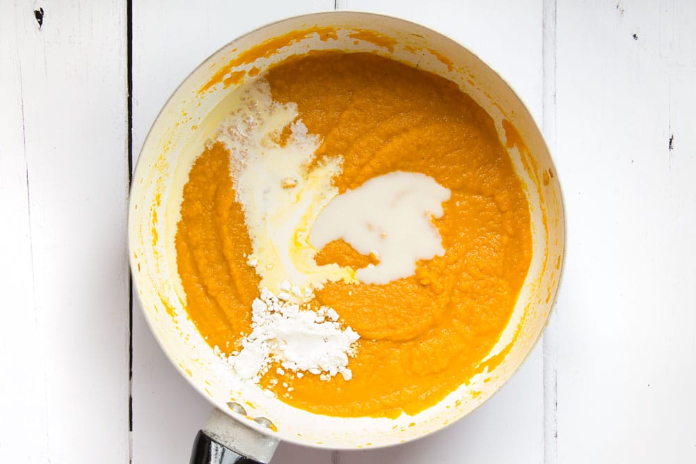 Further ingredients are added to the fragrant Thai carrot and coconut soup