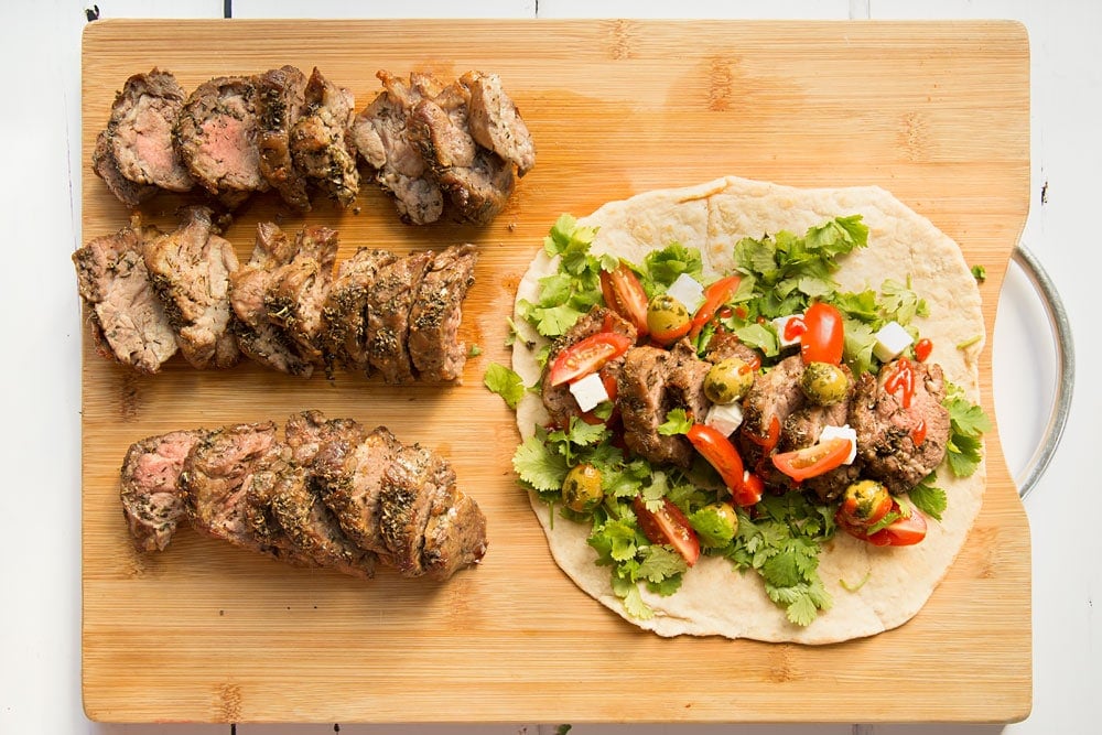 Assembling the herb crusted Welsh Lamb in a quick coriander flatbread wrap