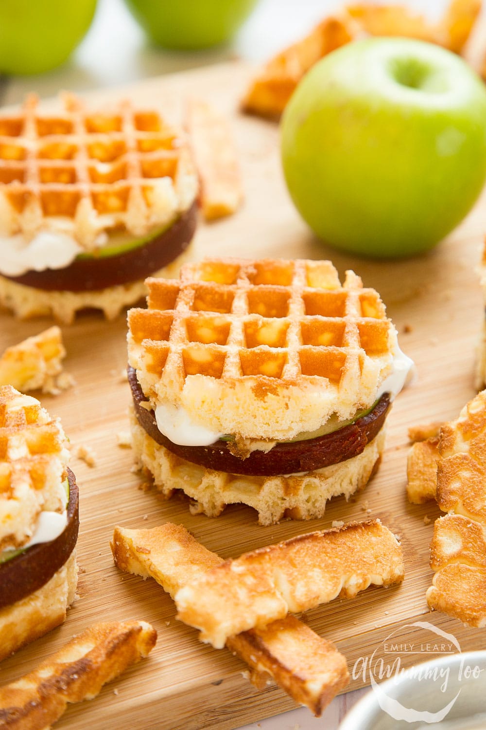 Front angle shot of Waffle apple burgers served on a white plate with a mummy too logo in the lower-right corner