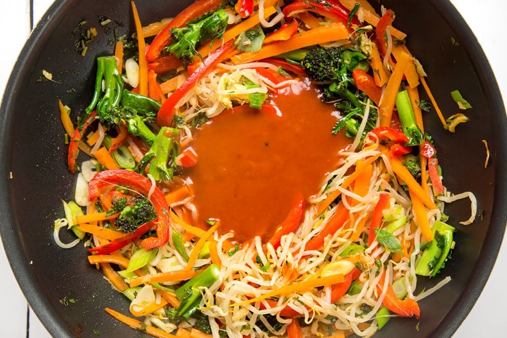 Sweet and sour sauce is added to the stir fry