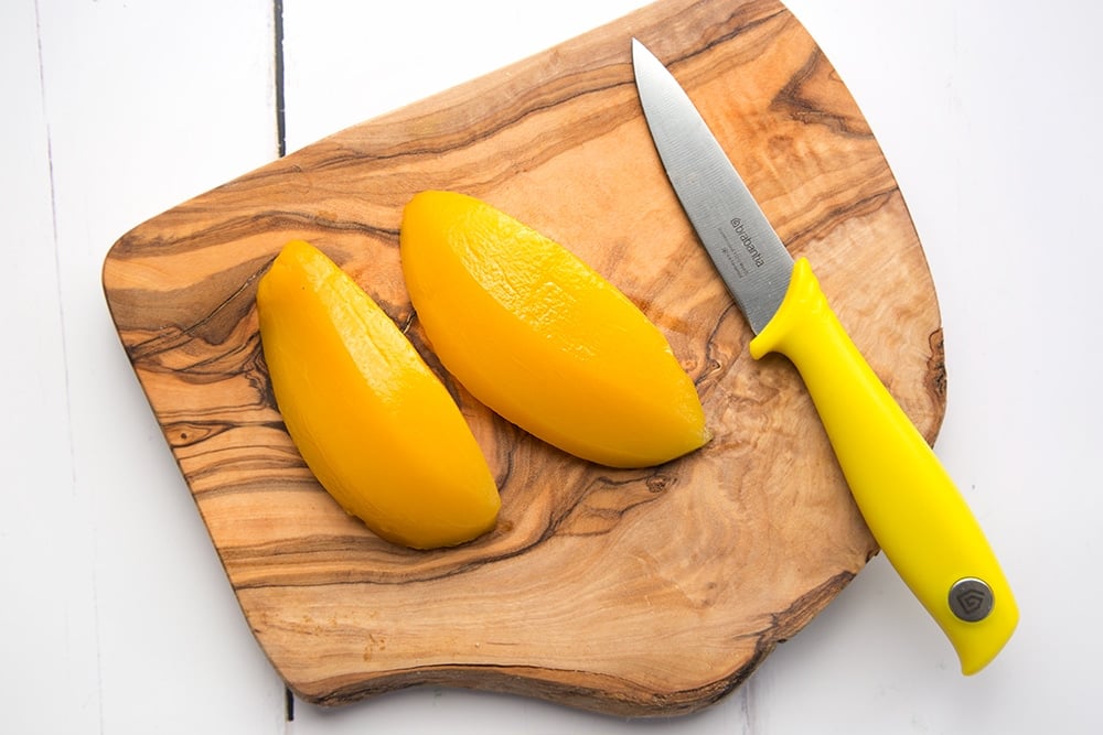 Preparing the mango by slicing into cubes