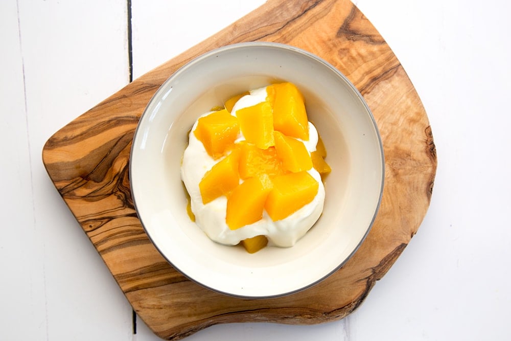 Add the remaining mango to create another layer in your breakfast bowl