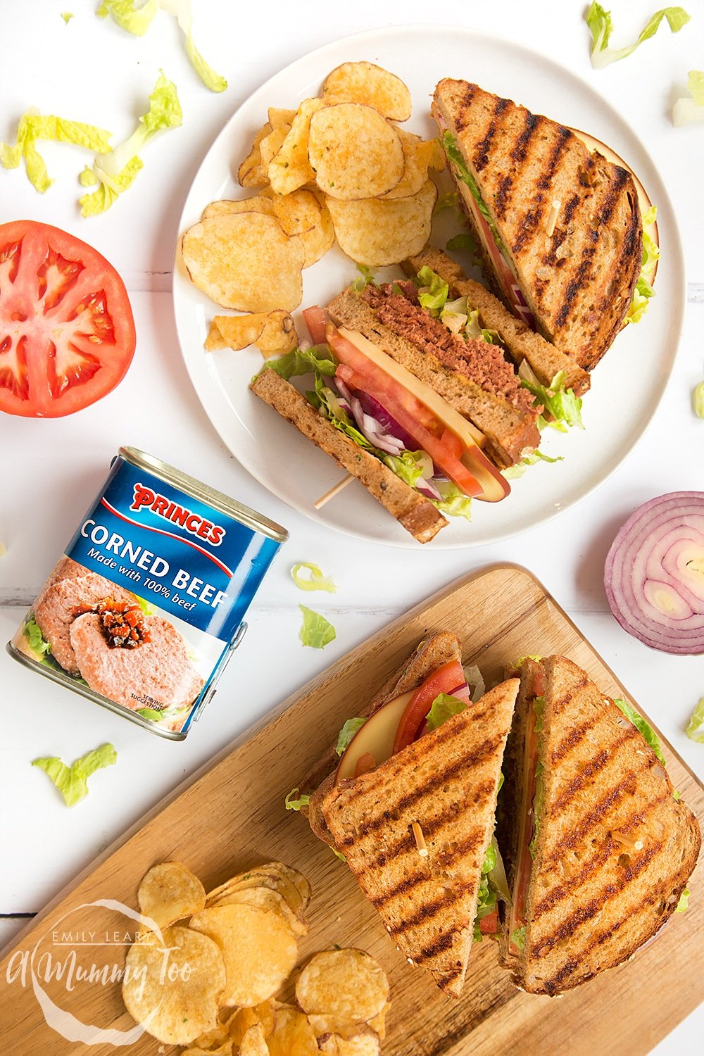 The finished deli-style corned beef on rye sandwich, shown alongside garnish and crisps