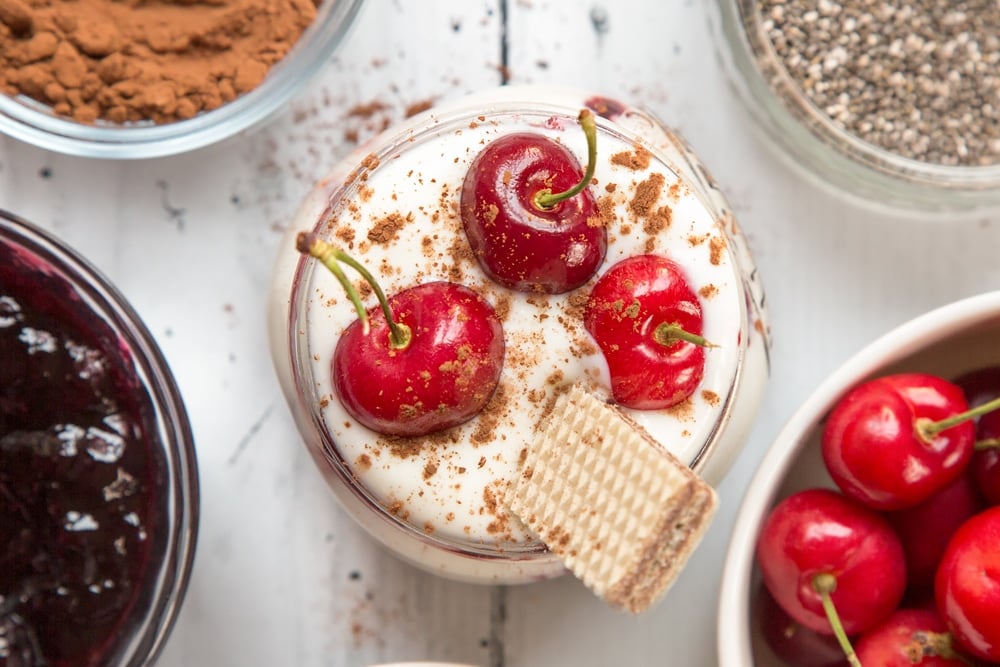 Sprinkled cocoa powder adds extra flair to the black forest breakfast jar