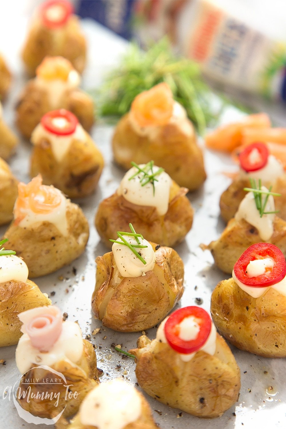 Close up of stuffed mini baked potatoes topped with Primula and toppings