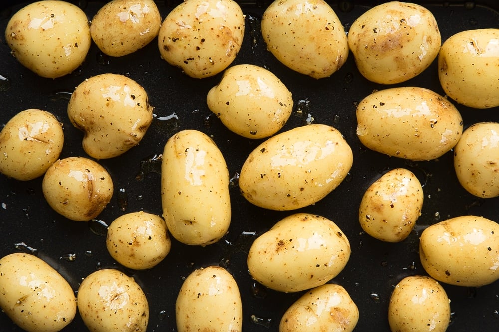 Mini potatoes drizzled with oil and a sprinkle of salt and pepper