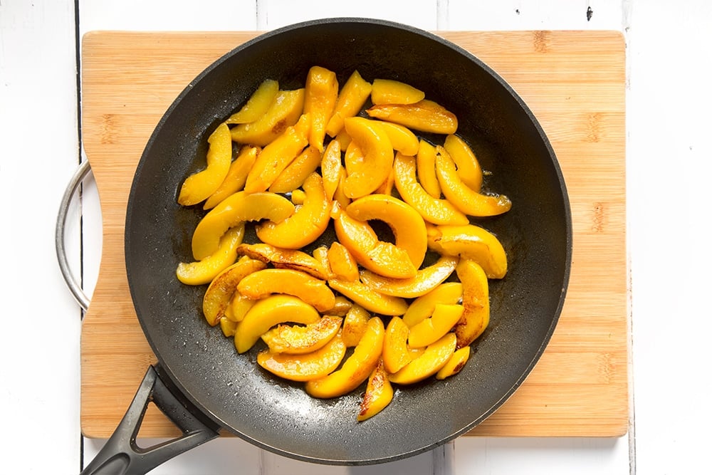 The peaches are warmed before being added to the cinnamon French toast