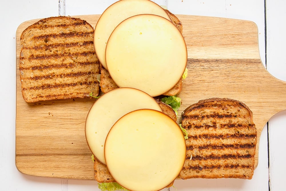 Smoked cheese is layered into the sandwich