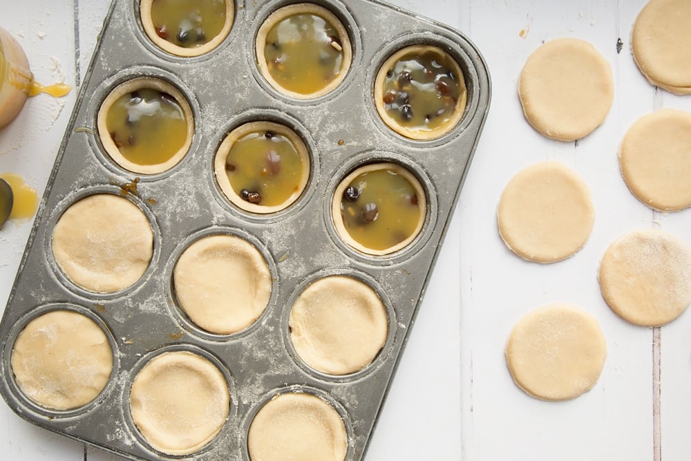 Top the salted caramel mince pies with a disc of pastry