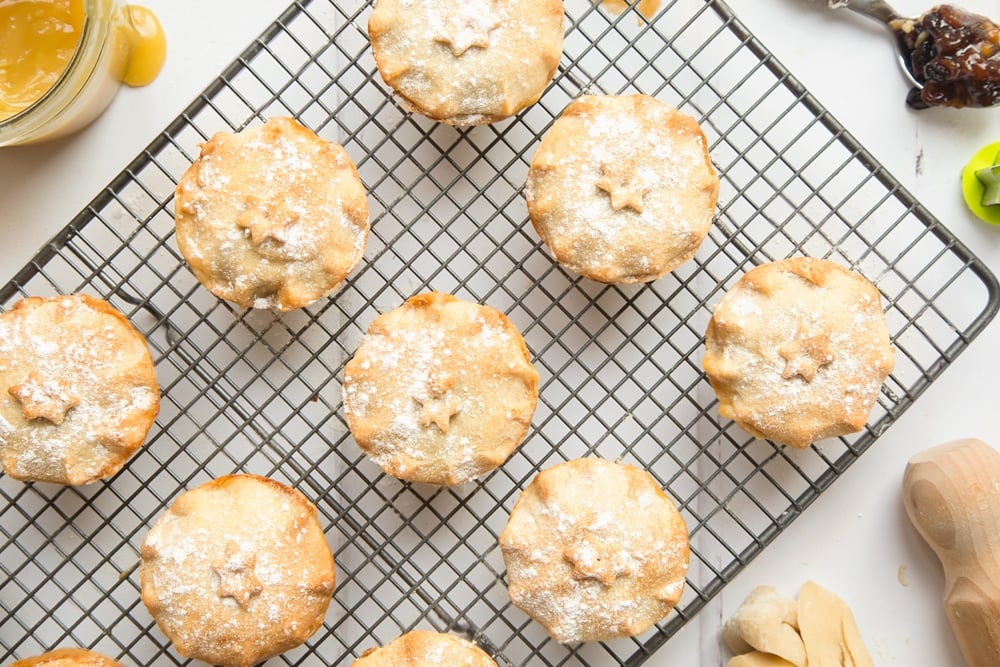 Freshly baked salted caramel mince pies topped with a dusting of icing sugar