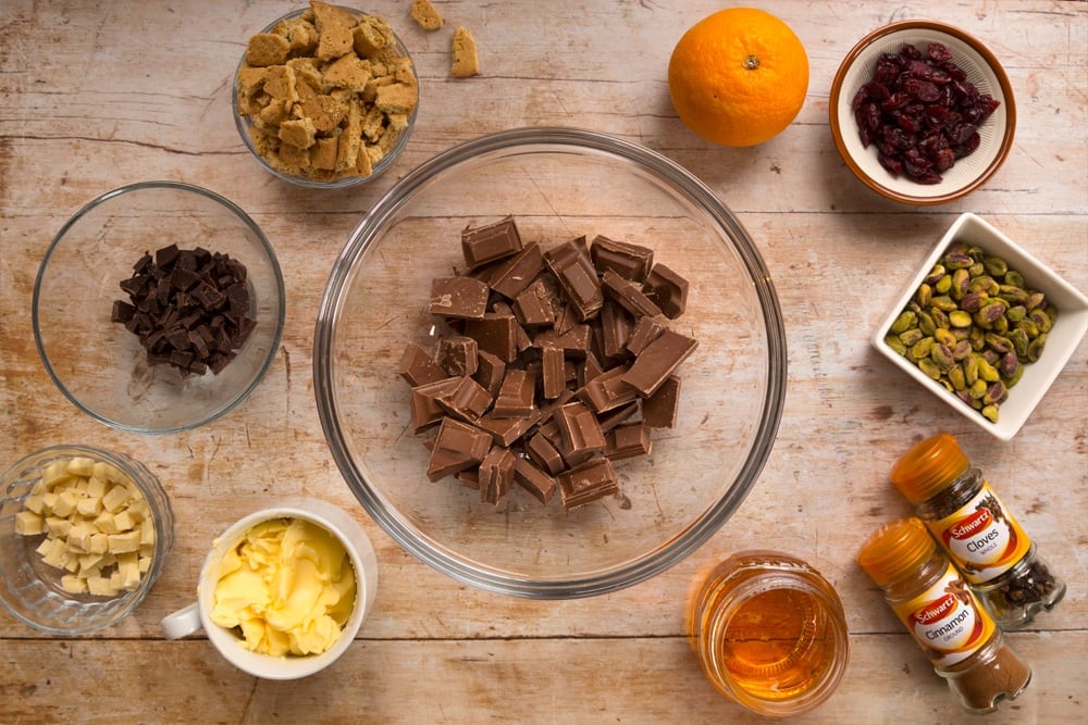 Ingredients for the Christmas spiced chocolate salami, shown in bowls alongside Schwartz spices