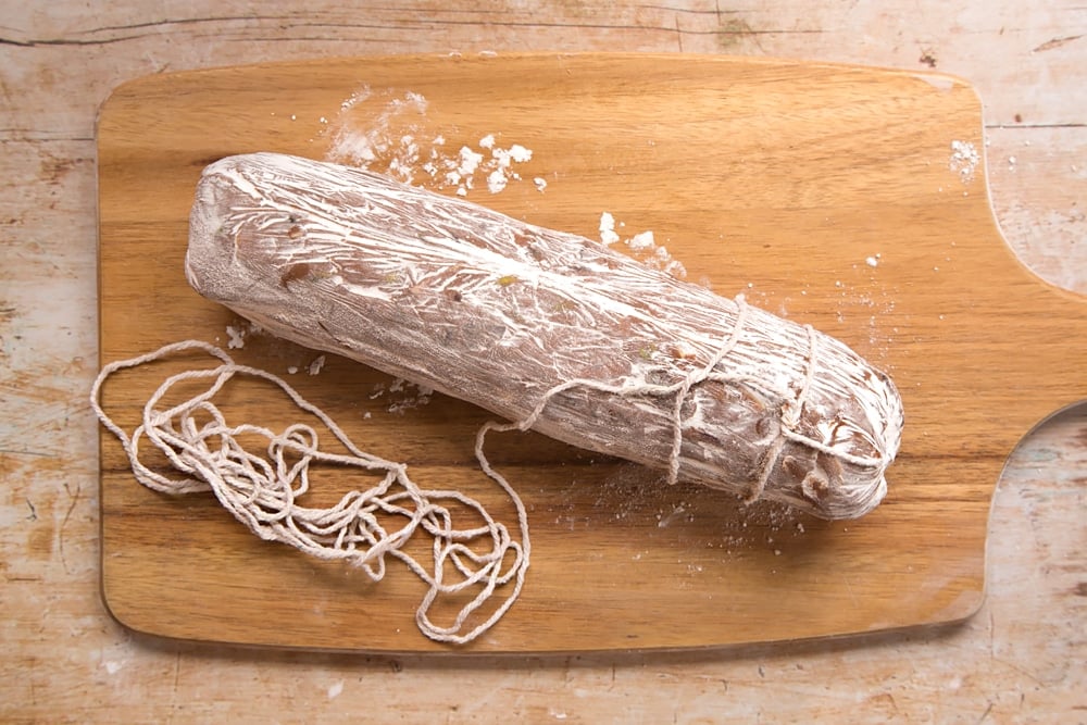 Decorating the Christmas spiced chocolate salami with food-safe string