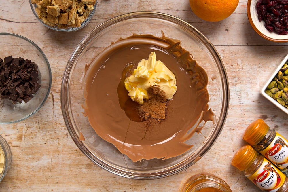 Step by step instructions to make Christmas spiced chocolate salami: add butter, golden syrup and cinnamon