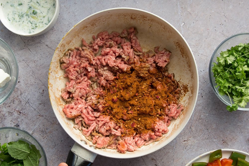 Ras el hanout is added to the frying mince