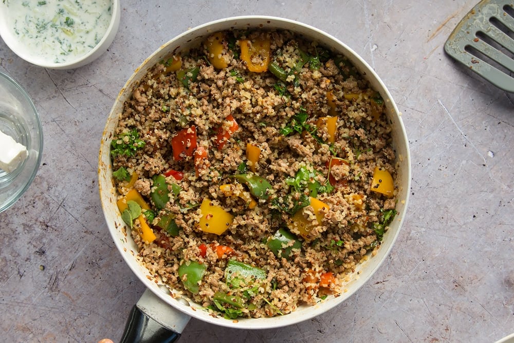 The finished aromatic lamb and warm grain salad, shown in a frying pan