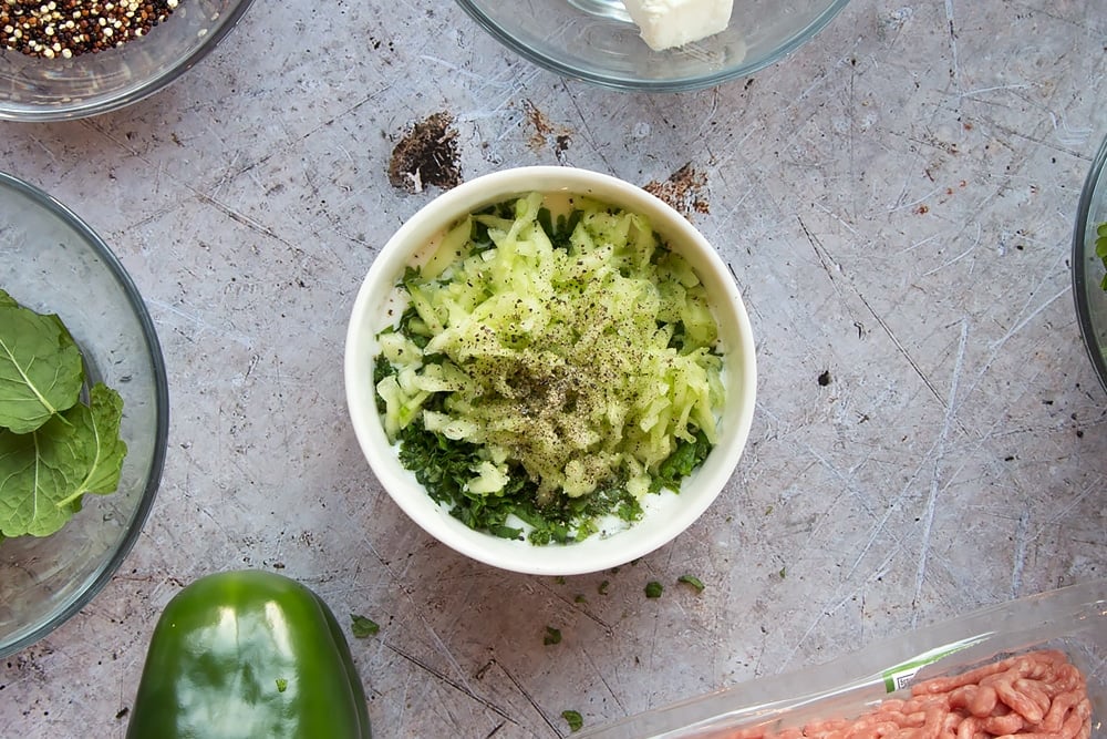 Adding the ingredients together to make tzatziki