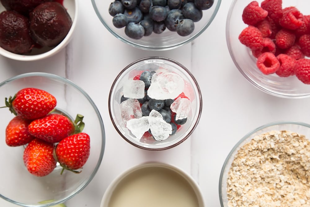 Fruits and nuts are mixed with ice in the first step to making this smoothie