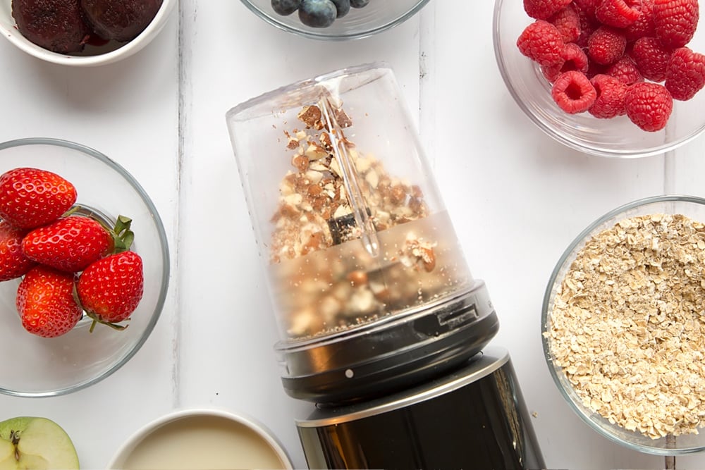 Chopped almonds are added to the vegan fruit and nut smoothie bowl