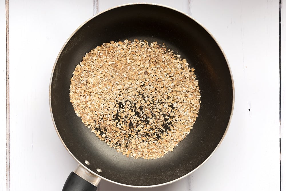 Golden brown toasted oats, part of this delicious and unusual breakfast coleslaw