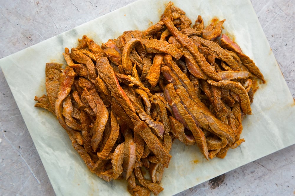 Slice the marinated steak against the grain