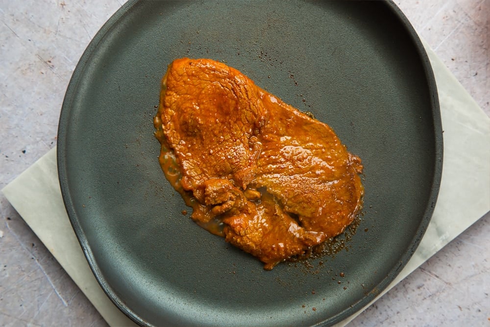 The marinated beef steaks are cooked over heat