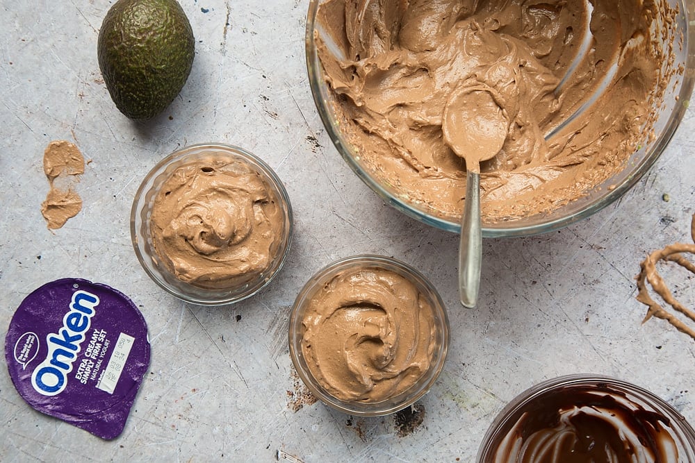 The creamy avocado yogurt chocolate mousse is spooned into pots and chilled