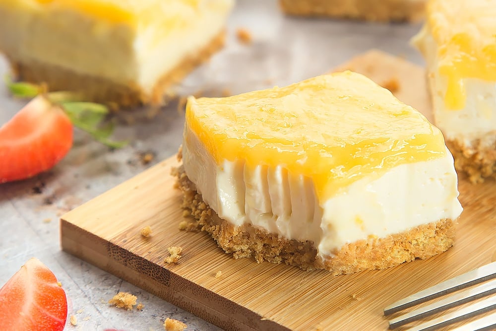 Cut the lemon curd yogurt cheesecake into bars and serve!