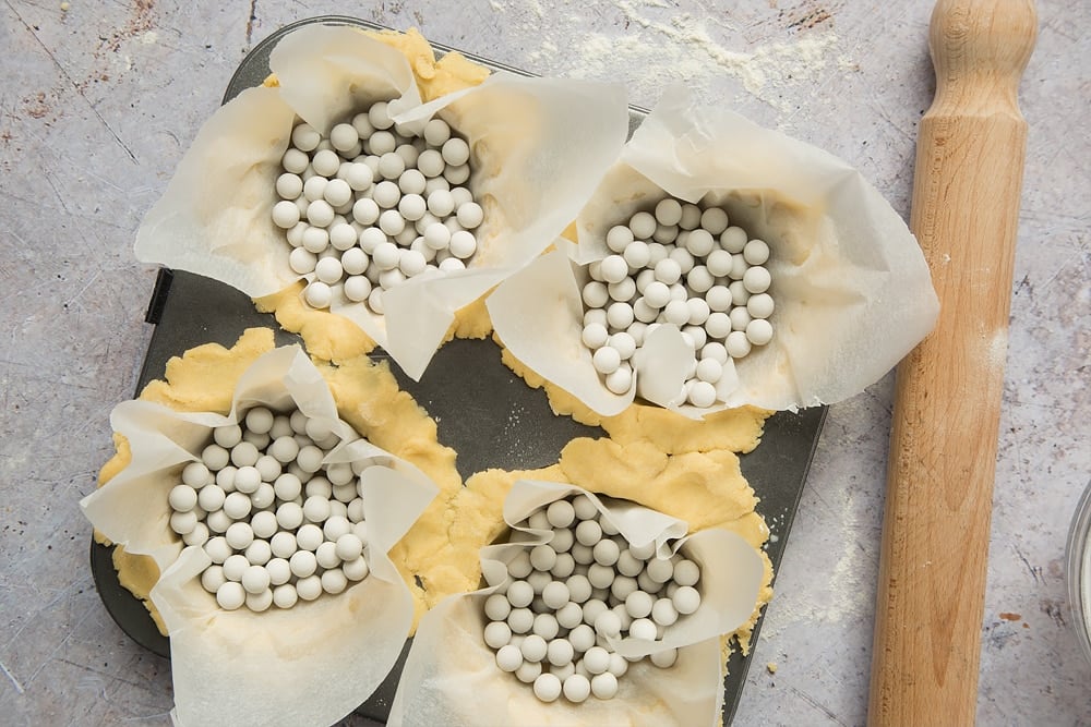 Baking beans are used to give the whipped yogurt fruit tarts their shape