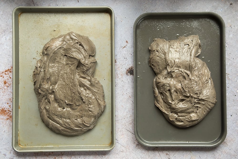 The sheet cake mix is divided between the two baking trays