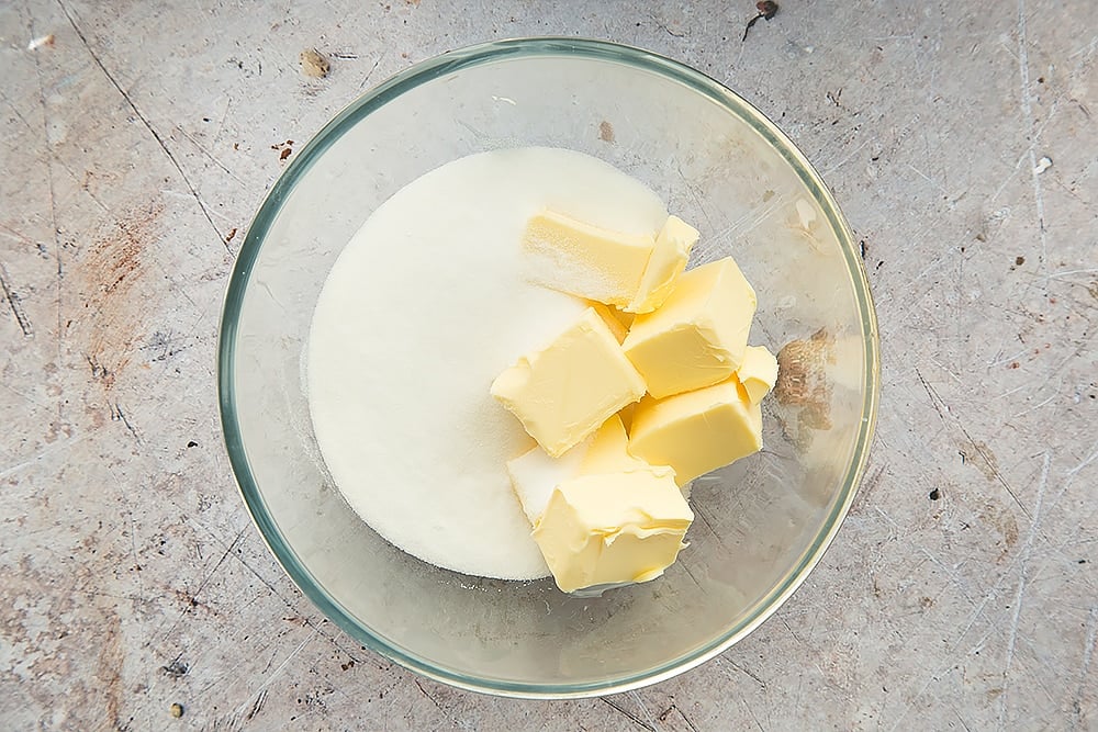 Butter and sugar, shown in a glass bowl