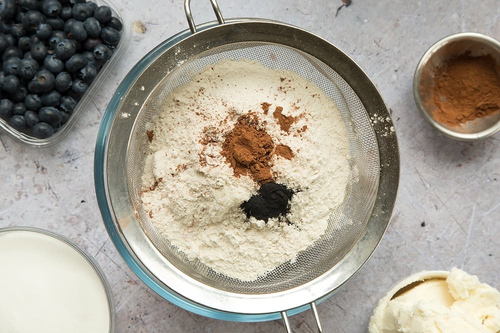 The dry ingredients for the black velvet sheet cake, featuring cocoa and activated charcoal