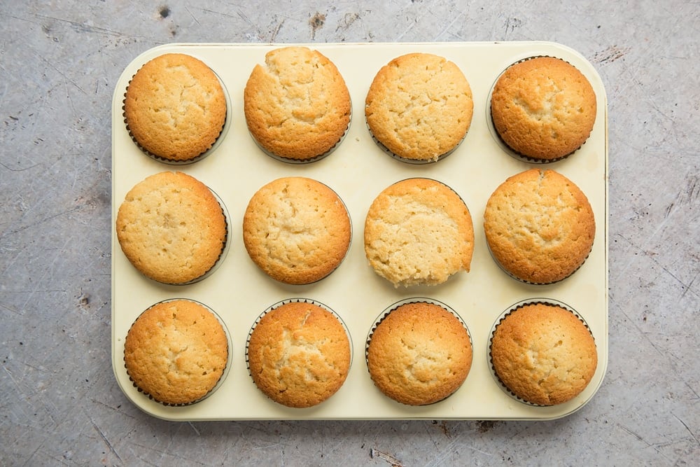 Freshly baked lemon cupcakes, ready to be iced