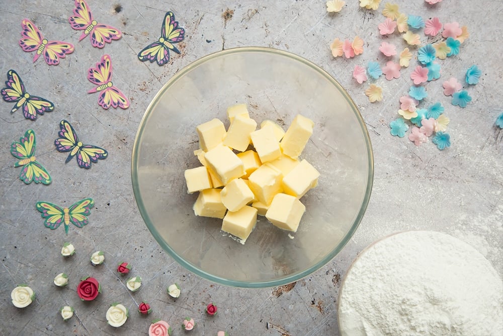 Cubed, softened butter is the first ingredient in making the delicious lemon buttercream frosting