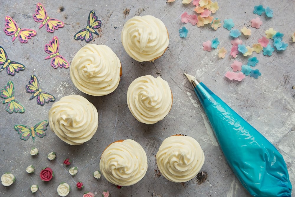 Generous swirls of lemon buttercream icing on top of the lemon cupcakes