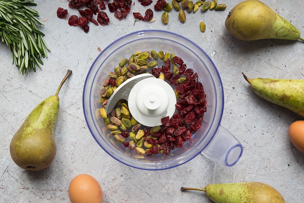 Cranberries and pistachios, shown in a blender