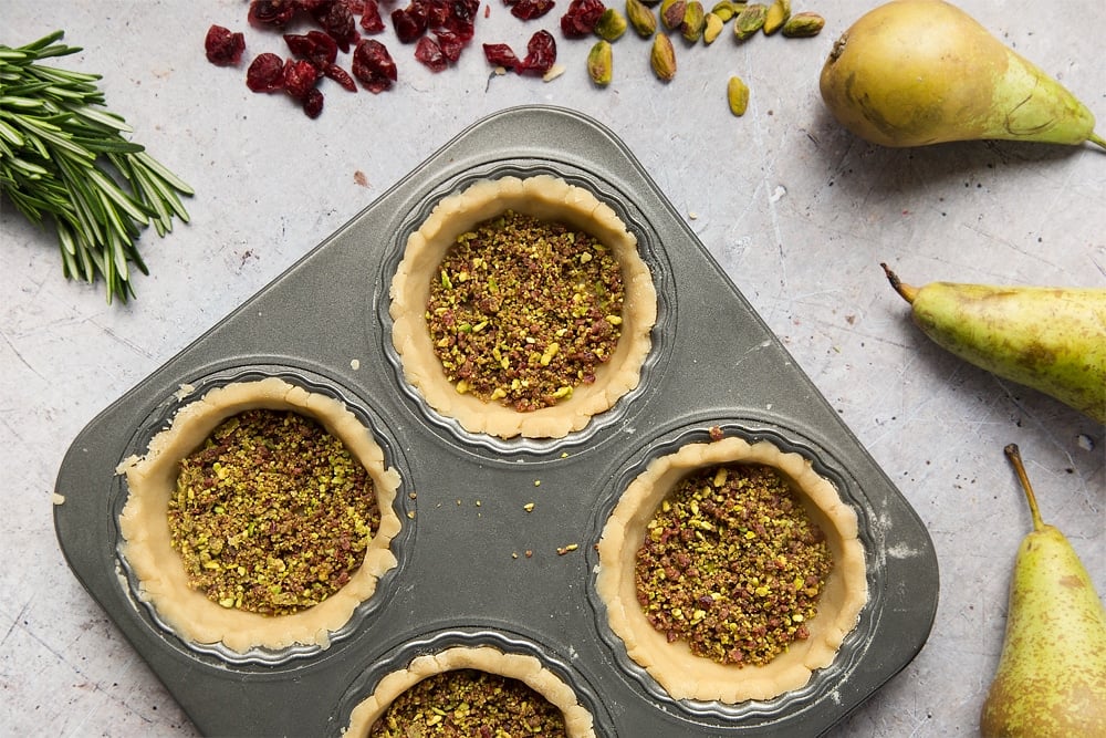 The cranberry and pistachio mix, spooned carefully into the tarts