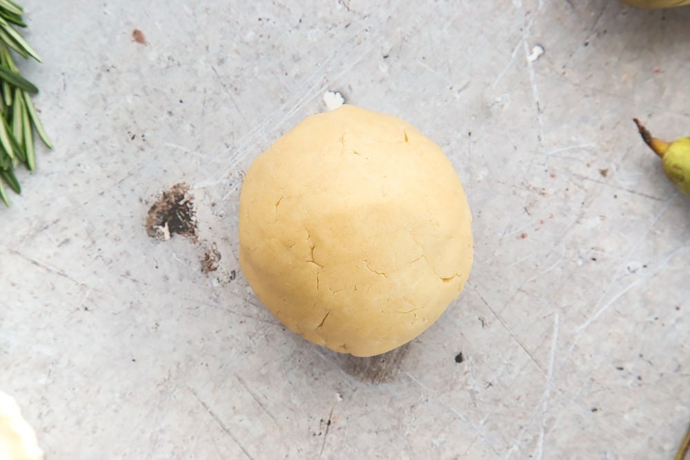 The tart dough is rolled into a bowl - shown here alongside rosemary