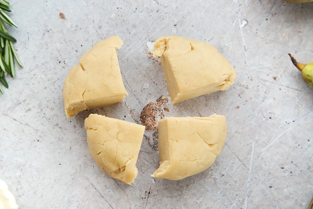 The tart dough is cut into four pieces