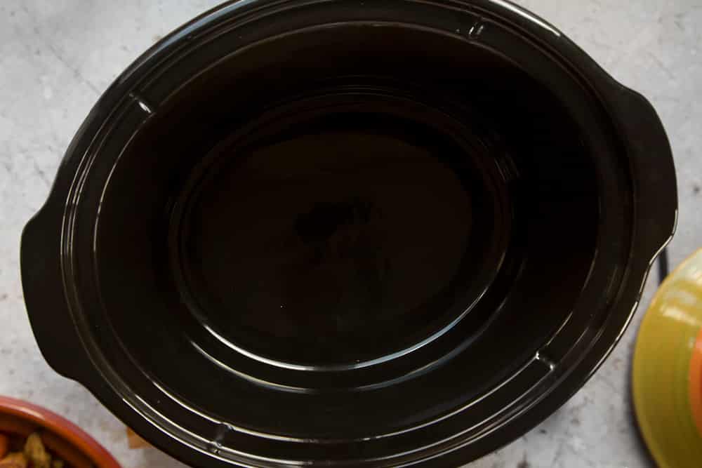 an empty slow cooker ceramic dish.