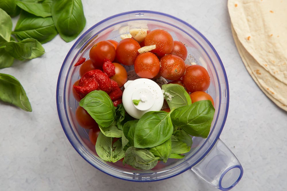 Mixing ingredients for the sauce in a food processor