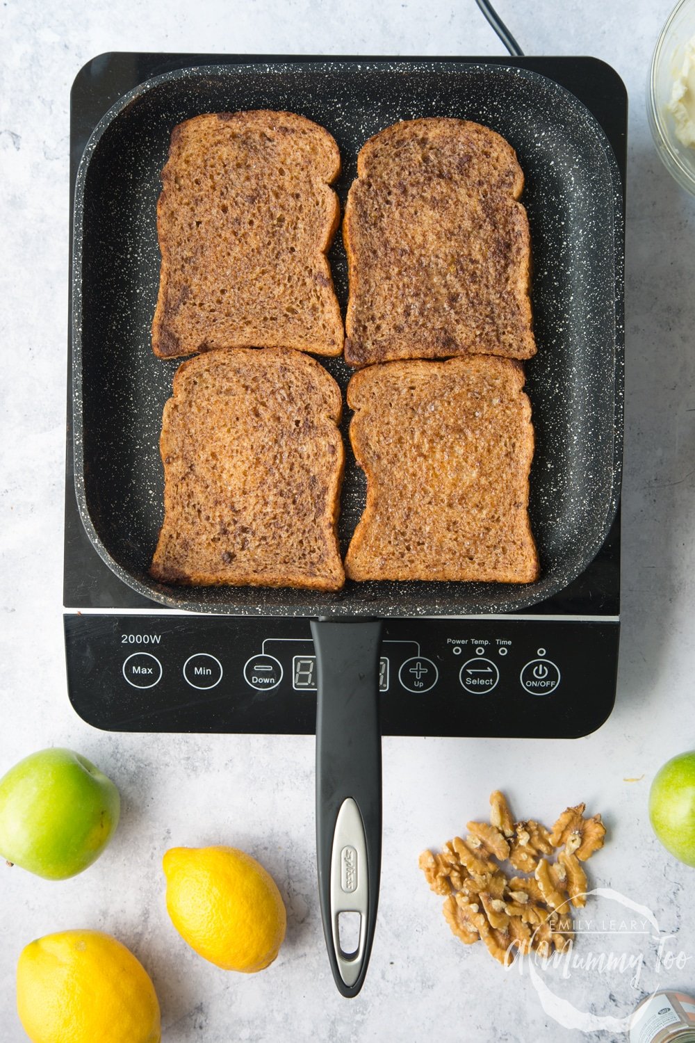 a griddle pan on an induction hob grilling 4 pieces of bread