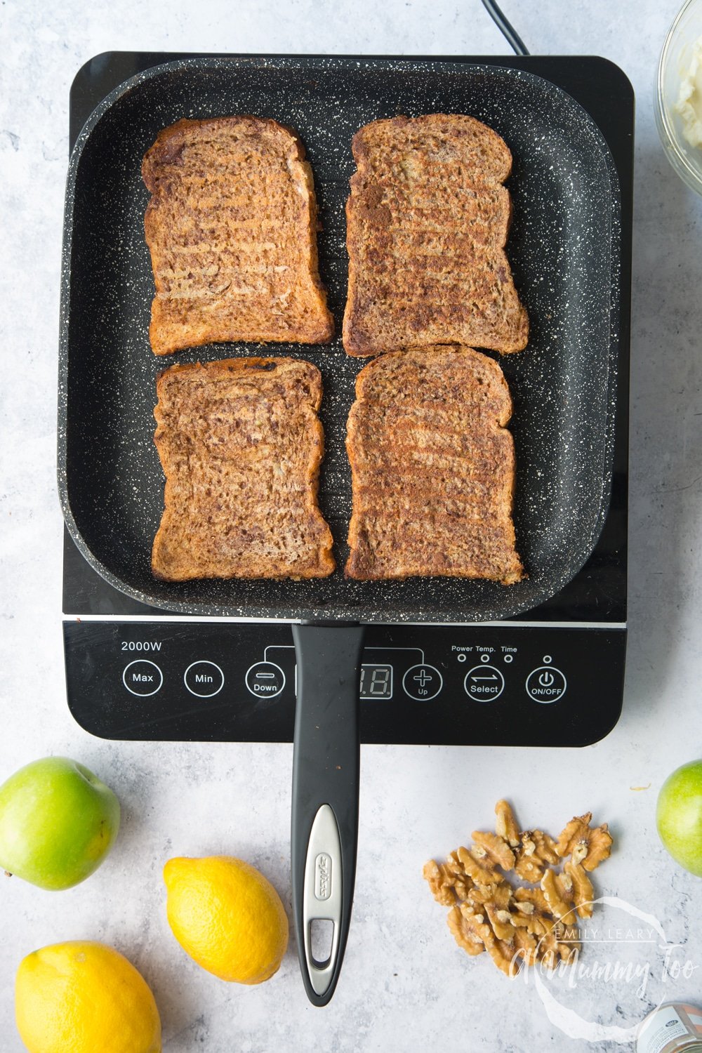 a griddle pan on an induction hob grilling 4 pieces of bread